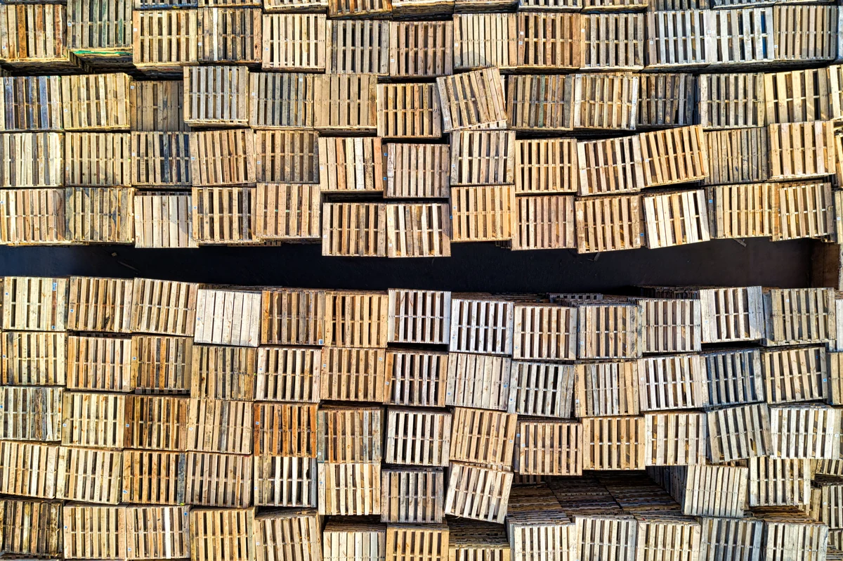 Wooden cargo pallets stacked in an industrial setting
